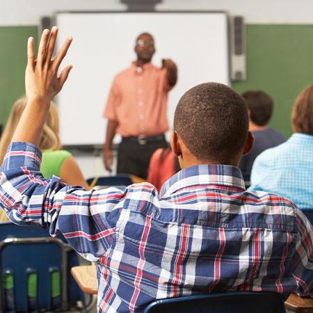 Student raising hand in class