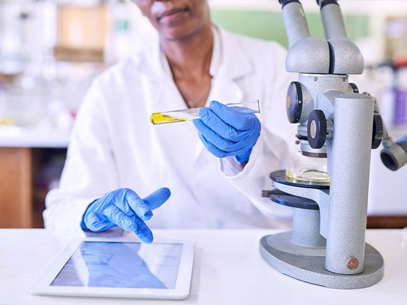 Scientist recording lab results on tablet