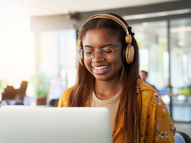 Young student wearing headphones applying online