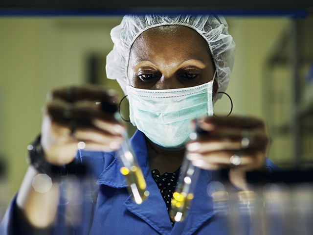 Scientist examining test tubes