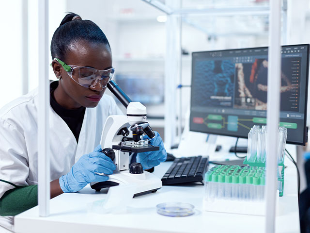 Scientist looking in microscope